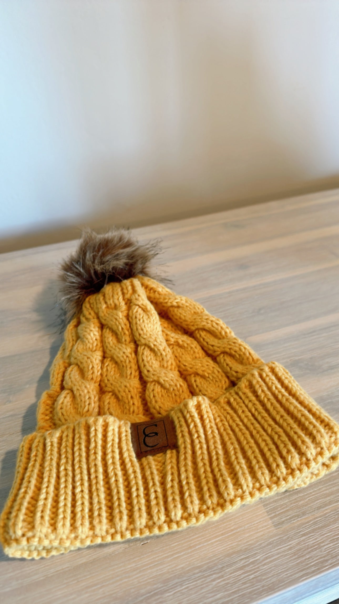 Yellow pom pom beanie