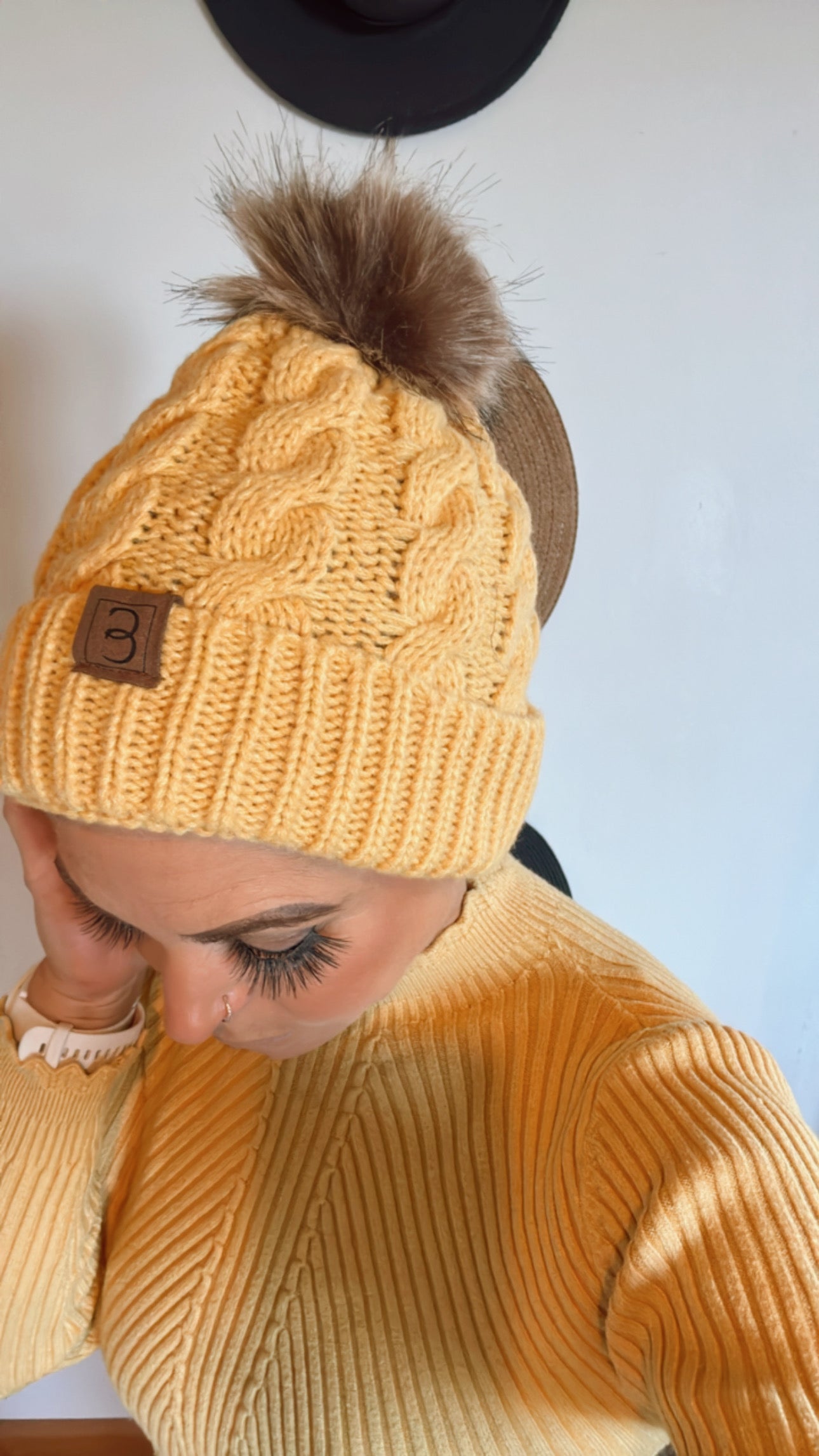 Yellow pom pom beanie